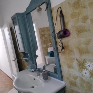 a bathroom with a sink and a mirror at Perlablu' Home in Anzio