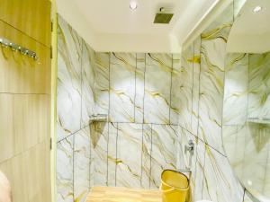 a bathroom with a shower with a marble wall at Hotel Innova By Bedrock Hospitality in Amritsar +26 photos