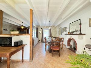 a kitchen and dining room with a table and a fireplace at La Gambade - Wifi, Jardin, BBQ, 1500 m de la mer in Mesquer +17 photos