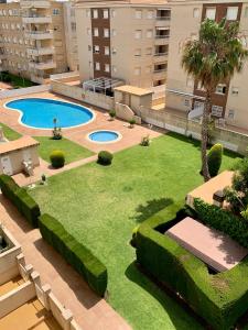 an overhead view of a yard with a pool and grass at Penthouse w/ sea view, pool & beach in Calafell