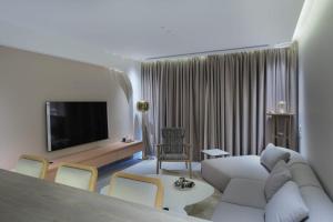a living room with a couch and a tv at The Red Residence North Coast Egypt in Mājid Abū Zayd