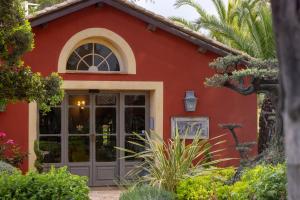 a red house with a large glass door at La Signoria & Spa in Calvi