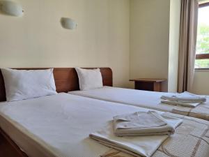 a bedroom with two beds with towels on them at Hotel Elica in Varna City