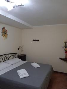 a bedroom with a bed with two towels on it at La Costa Del Sole in San Fele