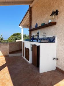 a kitchen with a sink on the side of a house at Suite Casa Paola in Casa De Giorgis +16 photos