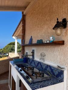 a kitchen with a sink and a counter top at Suite Casa Paola in Casa De Giorgis