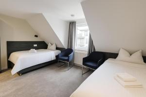 Postel nebo postele na pokoji v ubytování 3 Monkeys Hotel
