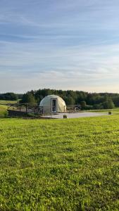 a large tent in the middle of a field at Saules sēta  +14 photos