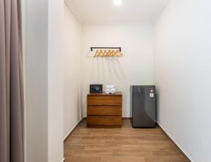 a room with a refrigerator and a wooden table at Beach8 Canggu By Kerta Living in Canggu