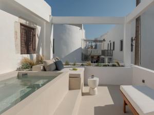 a white house with a swimming pool and a patio at Sifneos House in Naousa