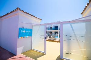a white garage with a sliding door next to a building at TAO El Cotillo - VV in El Cotillo