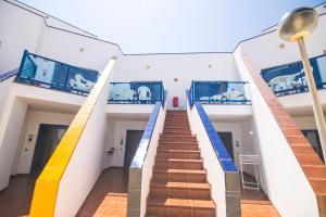 a staircase in a building with blue and yellow stairs at TAO El Cotillo - VV in El Cotillo