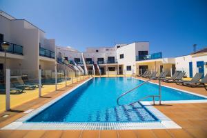 a swimming pool with a slide in a building at TAO El Cotillo in El Cotillo
