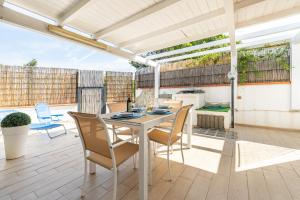 a patio with a table and chairs on a deck at Casa Nucci - Free WIFI - 100mt from the beach in San Stèfano