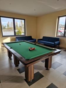 a billiard room with a pool table and couches at KR Pokoje in Tokarnia