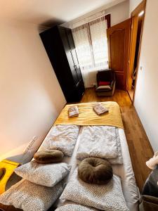 a room with a bed with two pillows on it at Bliss Apartment Balatonfured in Balatonfüred +42 photos
