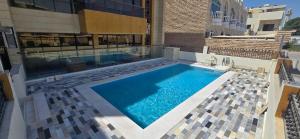 a swimming pool in the middle of a building at Nasma Homes in Abu Dhabi