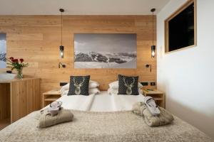 Ένα ή περισσότερα κρεβάτια σε δωμάτιο στο Hotel Dahu