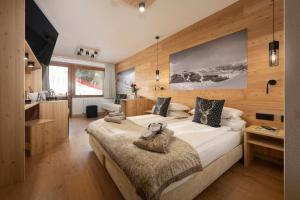 Ένα ή περισσότερα κρεβάτια σε δωμάτιο στο Hotel Dahu