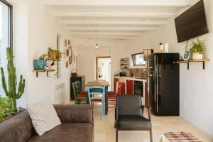 a living room with a couch and a refrigerator at Trullo Elce 11 in Putignano