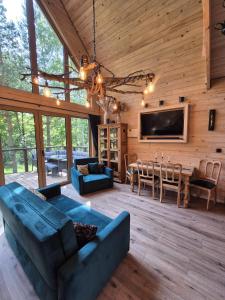 a living room with a couch and a dining room at Woodland House 1 in Berezka