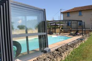 a glass house with a swimming pool next to a house at B&B La Ferme de la Patte d'Oie in Saint-Michel-Saint-Jaymes +21 photos