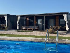 a house with a swimming pool in front of it at Ausblick Sunce i More Mobilehome in Pirovac