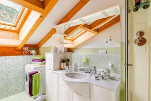 a bathroom with a sink and a window at Mansarda sul Lago di Molveno in Molveno +43 photos