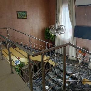 a bunk bed with a metal railing in a room at ANGELS COURT HOTEL and SUITES in Kuchbuni
