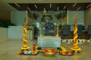 a room with a altar with yellow and red flowers at Hotel Tulips Grand in Hyderabad