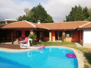 a house with a swimming pool in front of it at San Marco Villas in Kranevo