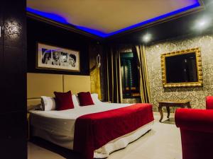 a bedroom with a bed and a tv in a room at Hotel Años 50 in Torremolinos