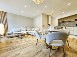 a living room with a couch and a table and chairs at Le Championnet - Proche du Port in Antibes