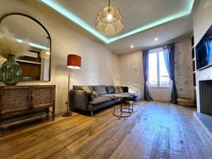 a living room with a couch and a fireplace at La Fourmilière - dans le Vieil Antibes in Antibes
