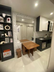 a kitchen with a wooden table and a counter at Oldquater cozyAPT Kingbed in Hanoi