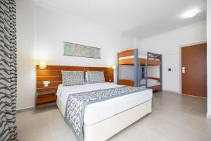 a bedroom with a bed and a bunk bed at Petunya Beach Resort in Ortakent