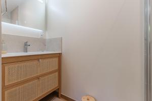 a bathroom with a sink and a mirror at La Maison du Martrait - Proche de la plage in Graye-sur-Mer +4 photos