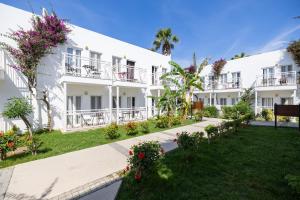 a view of the courtyard of a building at Petunya Beach Resort in Ortakent +54 photos