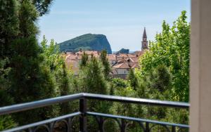 a view of a city from a balcony with trees at Hotel Majestic in Budva