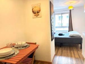 a room with a table and a room with a bed at Studio N216 Quiet and functional in Paray-le-Monial