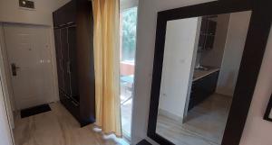 a mirror in a room with a bathroom at Apartments Danilo Kažanegra in Sveti Stefan