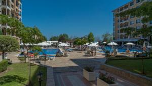 a resort with a pool and chairs and umbrellas at Bendita Mare Golden Sands Bulgaria in Golden Sands