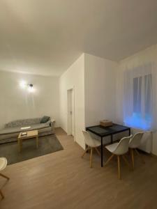 a room with a table and chairs and a bed at GreBen Apartmanok in Eger +8 photos