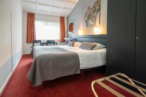 Postel nebo postele na pokoji v ubytování Veluwe Hotel Stakenberg
