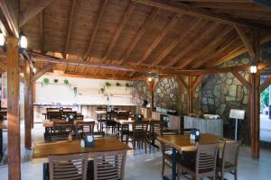 a dining room with wooden tables and chairs at Woodline Hotel in Kemer