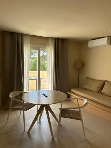 a living room with a coffee table and a bed at Serena Sol Apartments - Adults Only - Over 12 in Cala Serena