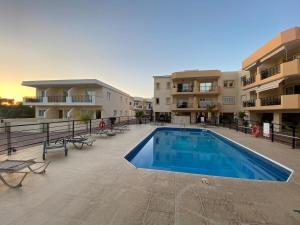 a swimming pool in front of a apartment building at Poolside Escape - Polis in Polis Chrysochous