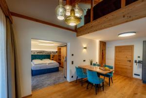 a room with a table and chairs and a bed at Gästehaus beim Foidlmoar Familie Höflinger in Reit im Winkl