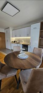 a kitchen with a large wooden table and chairs at Sanela's Peace in Vrnjačka Banja