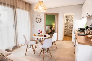 a kitchen and dining room with a table and chairs at Galatea Suites in Kalyves Poligirou